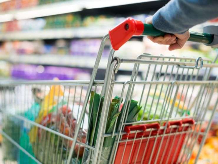 persona che spinge carrello al supermercato